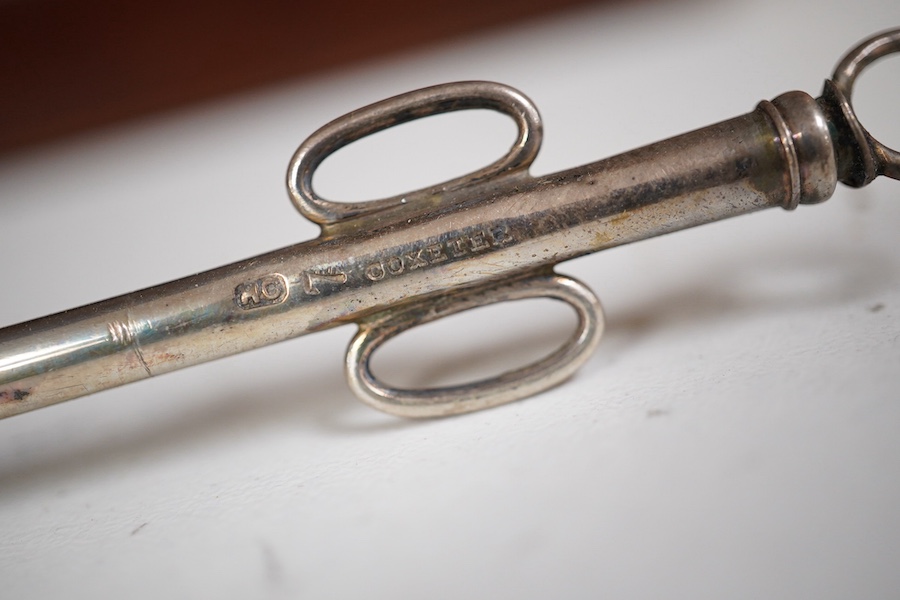 A mid 19th century mahogany cased medical set of catheter surgical instruments, inset plate to the lid engraved with ‘Wimbledon 1865. T. Wright, RHR’, 33cm wide. Condition - fair to good.